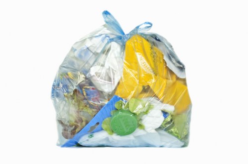 Workers loading a van with debris during a shop clearout in Gipsy Hill